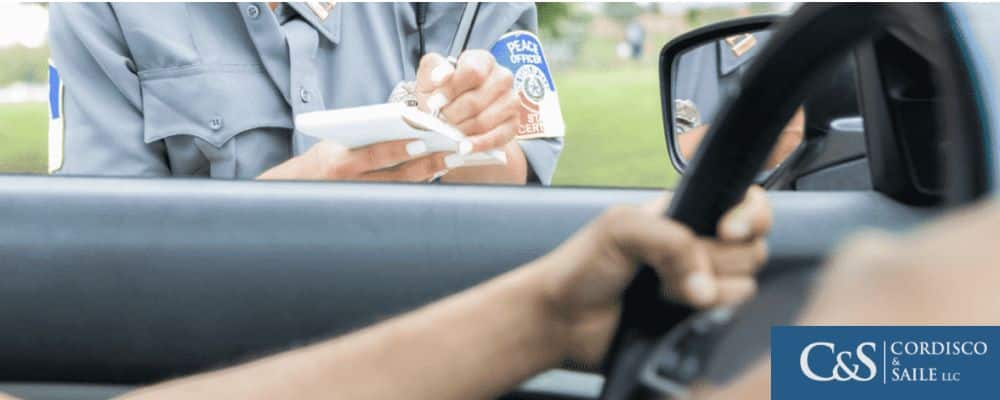 Police officer writing a ticket to a traffic offender