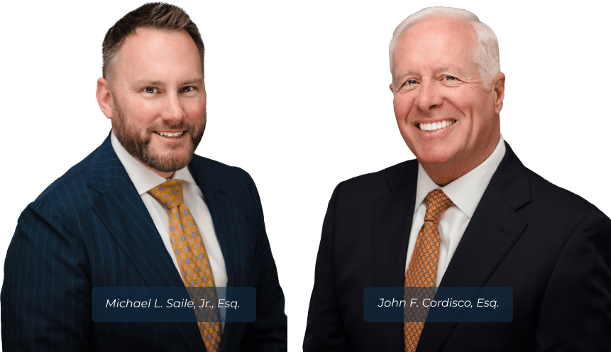 An image of Michael Saile and John Cordisco dressed in suits, both with smiles on their faces, depicting a scene of success or satisfaction in their professional lives as lawyers - Personal injury lawyers serving Bucks County, Philadelphia, and other local areas in Pennsylvania