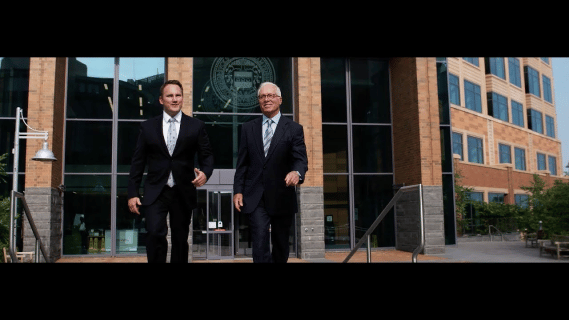 John Cordisco and Michael Saile walking out of building