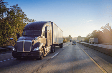 Semi truck driving on road during daytime - truck accident lawyer