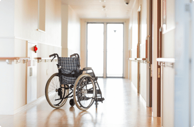 wheelchair parked in the middle of nursing home hallway - nursing home abuse lawyer