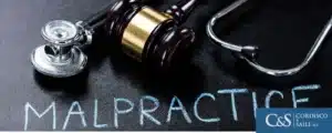 gavel and stethoscope sitting on desk