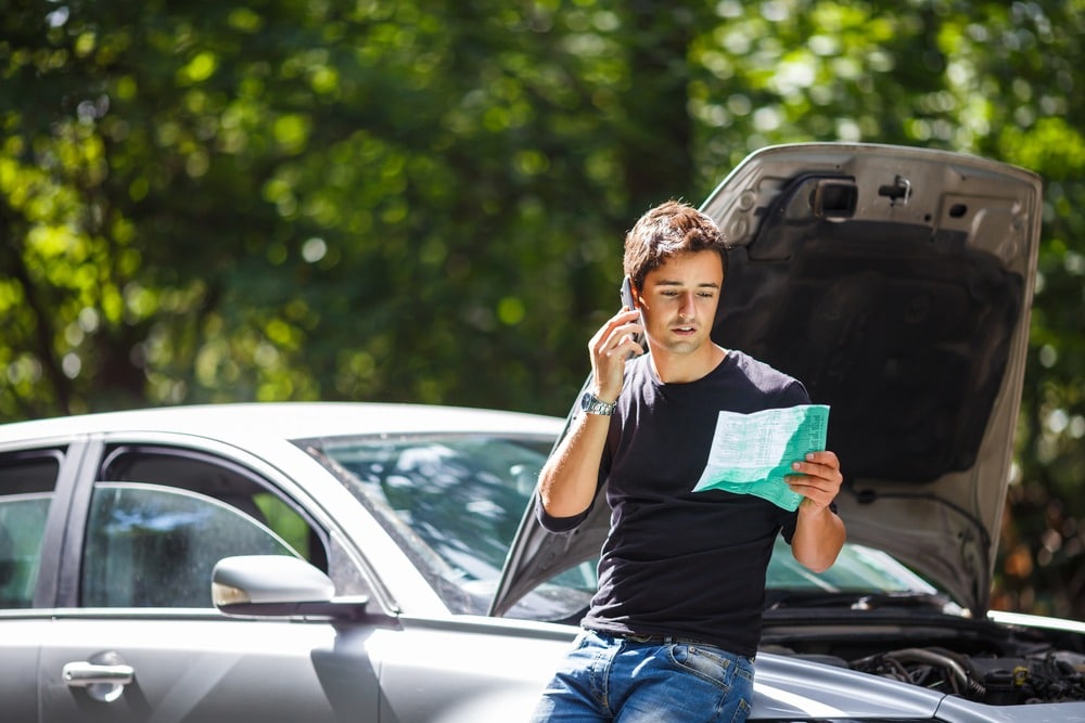 man on phone after car accident