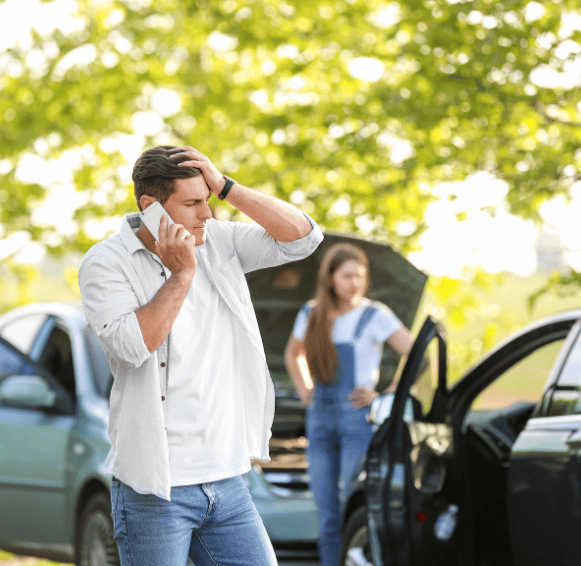 Man on phone after car accident