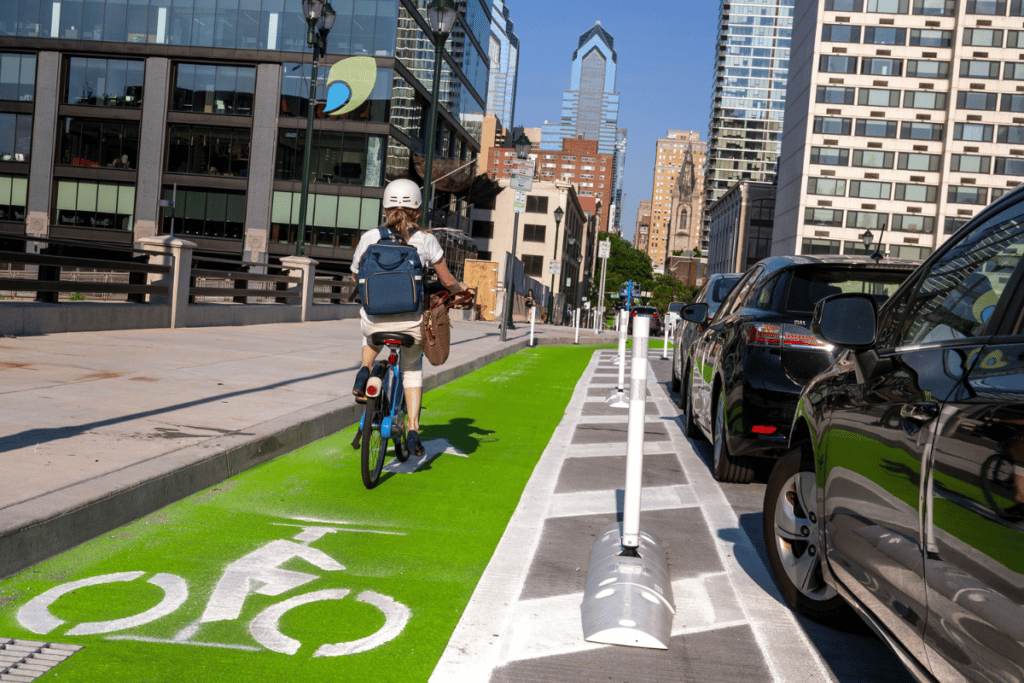 An image of a biker riding a bicycle in Philadelphia during daylight hours, possibly navigating through the city streets or exploring the local scenery.