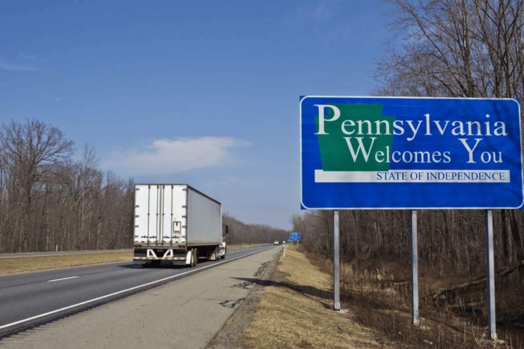 Truck on highway with Pennsylvania Welcomes You sign