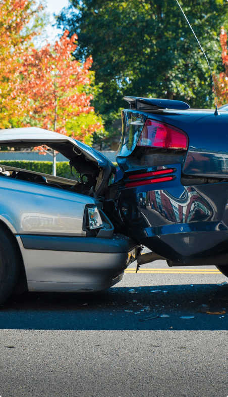 An image of two vehicles that have collided with each other, causing damage to the front and back ends of both cars