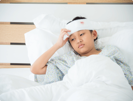 An image of a young girl lying on a hospital bed with a bandage on her head, having received treatment for injuries sustained in an accident.