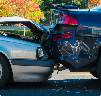 An image of two vehicles that have collided with each other, causing damage to the front and back ends of both cars