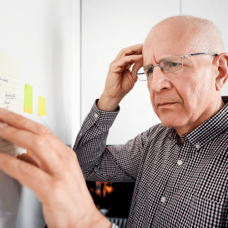 An elderly man touching his head because of a serious pain