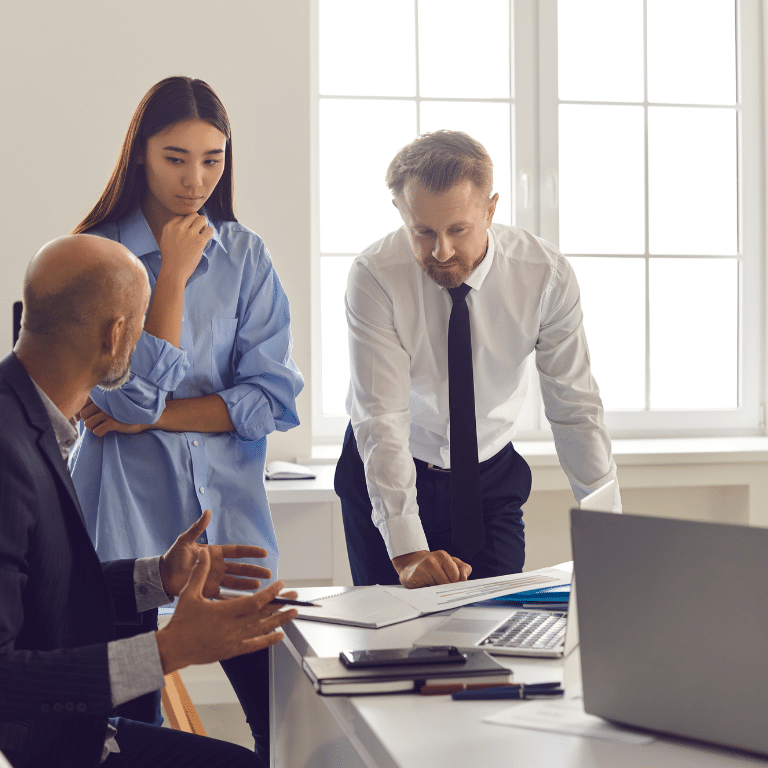 Coworkers gathering around a table to for discussion