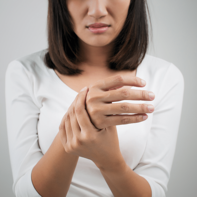 Woman holding her wrist