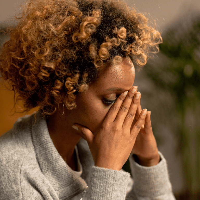 Black woman placed her hands on chin in distress