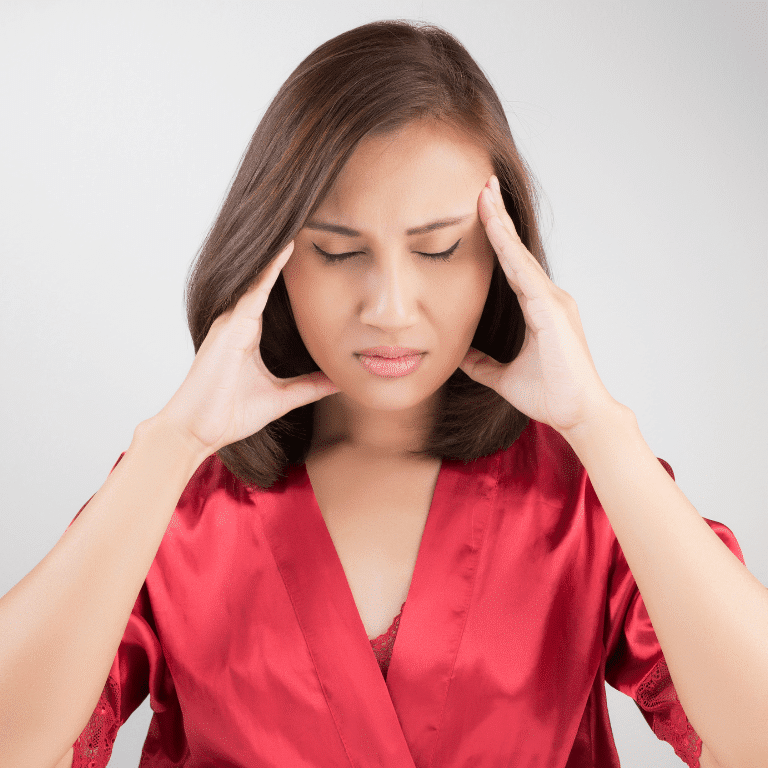 Woman holding her head because of a serious head pain