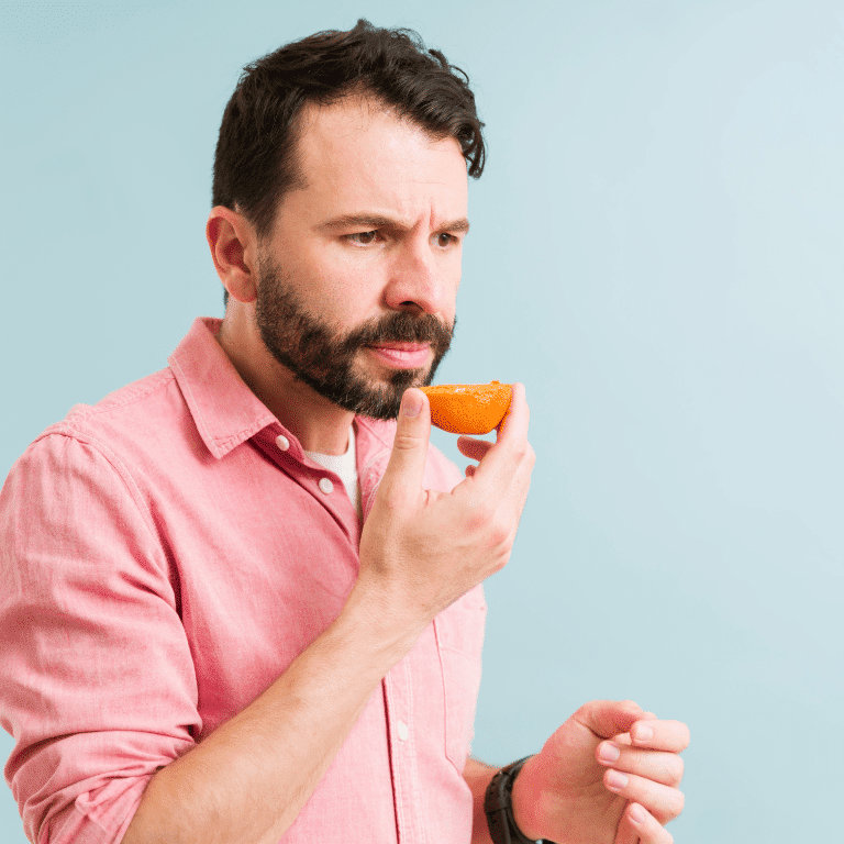 Man contemplating with an orange