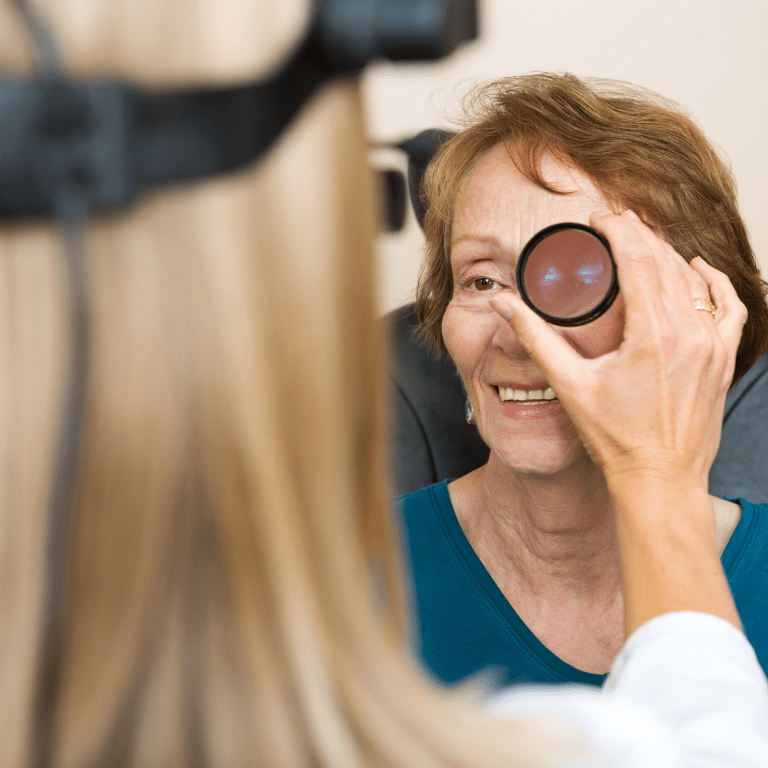 Doctor checking the eyes of an elderly woman