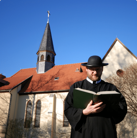 A clergy man reading the bible
