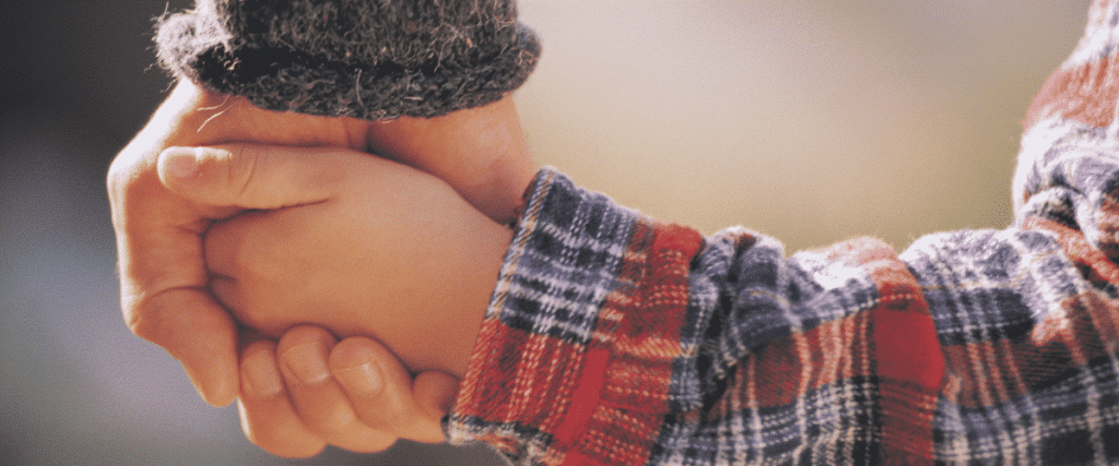 Child holding parents hand