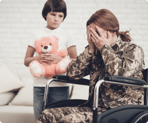 A veteran woman suffering from CRPS sitting on a wheelchair with daughter standing by the side