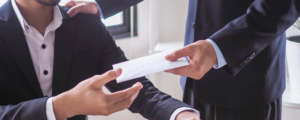 lawyer giving envelope of money to client