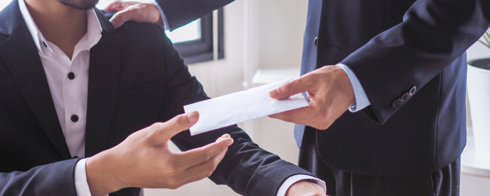 lawyer giving envelope of money to client