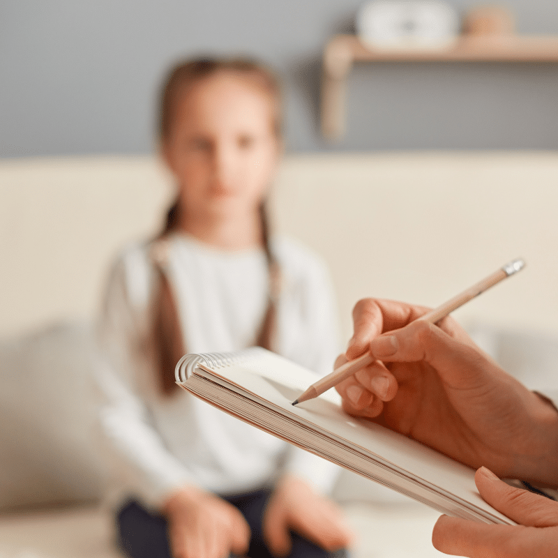 child looking at man with clipboard