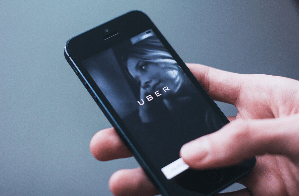 image of woman holding phone with uber app open