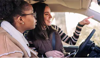 people in vehicle pointing out of window