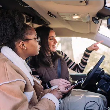 people in vehicle pointing out of window
