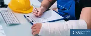 Injured worker filling out a claim form for workers compensation