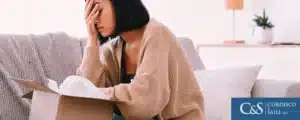 Woman placing her palm on her face head because of a wrongful death of her loved one