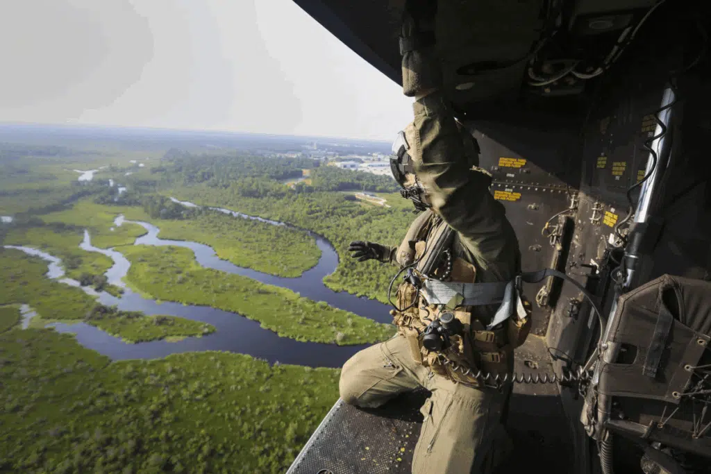 military member looking out from side of plane