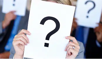 group of people holding up question mark signs