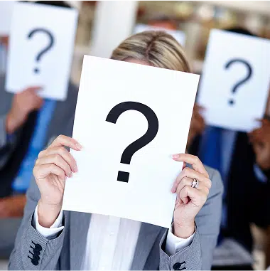group of people holding up question mark signs