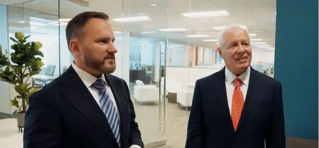 John Cordisco and Michael Saile talking to client