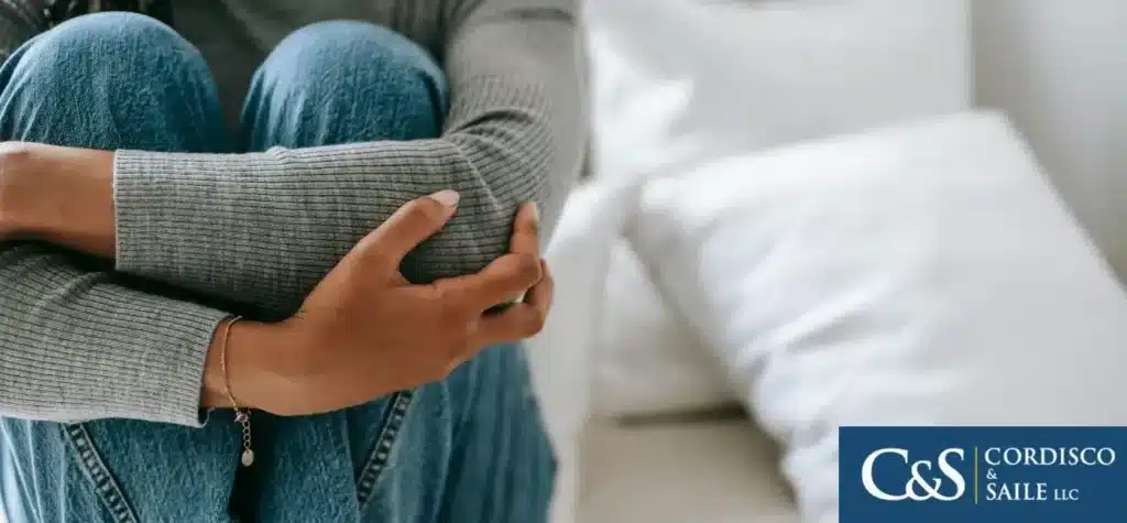 child clutching their knees