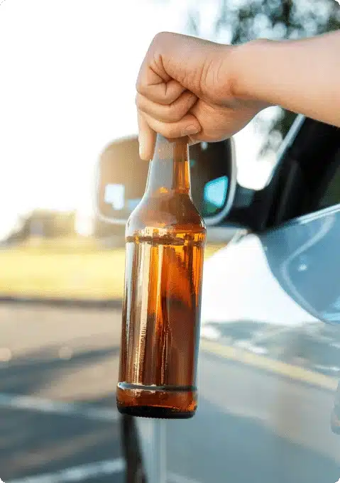 an empty bottle being held by someone