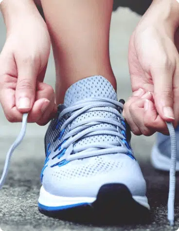 person tying their shoelaces