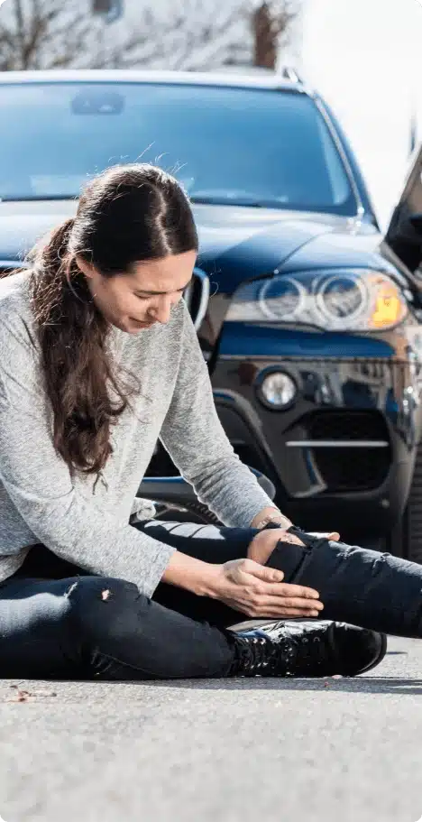 person holding knee after car accident