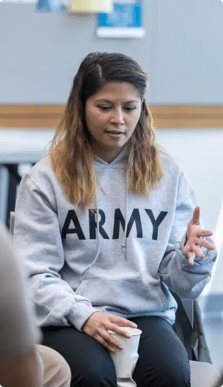 service member talking to group
