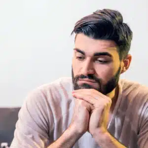 man sitting down and thinking