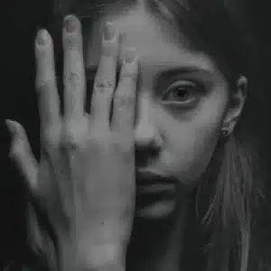 portrait of girl with hand covering one side of her face