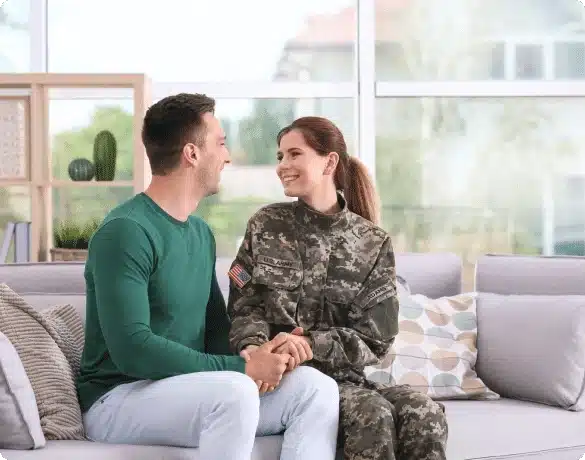 service member holding hands with loved one