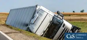 truck turned over on the side of the road