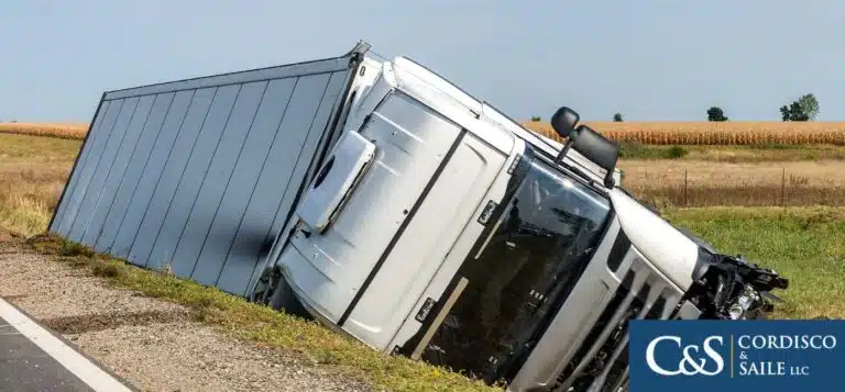 truck turned over on the side of the road