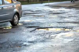 Pothole car accident lawyer Philadelphia investigating road hazards