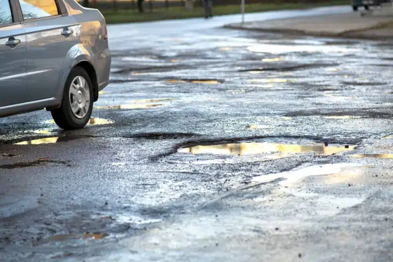 Pothole car accident lawyer Philadelphia investigating road hazards