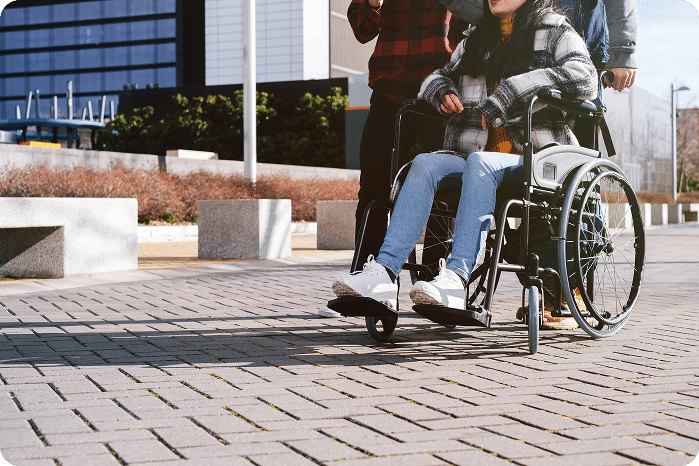 Close up of a person in a wheelchair with friends